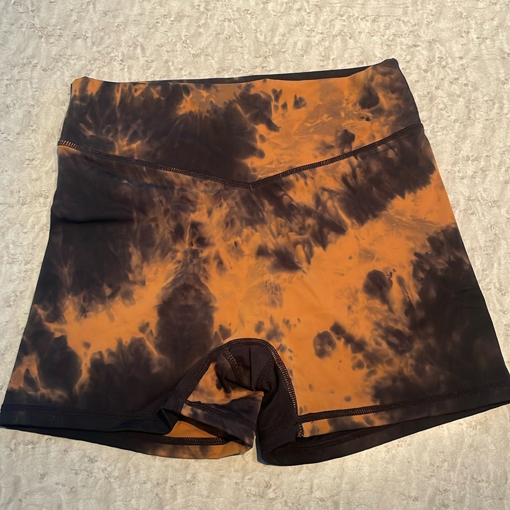 Black and orange tie-dye spandex shorts